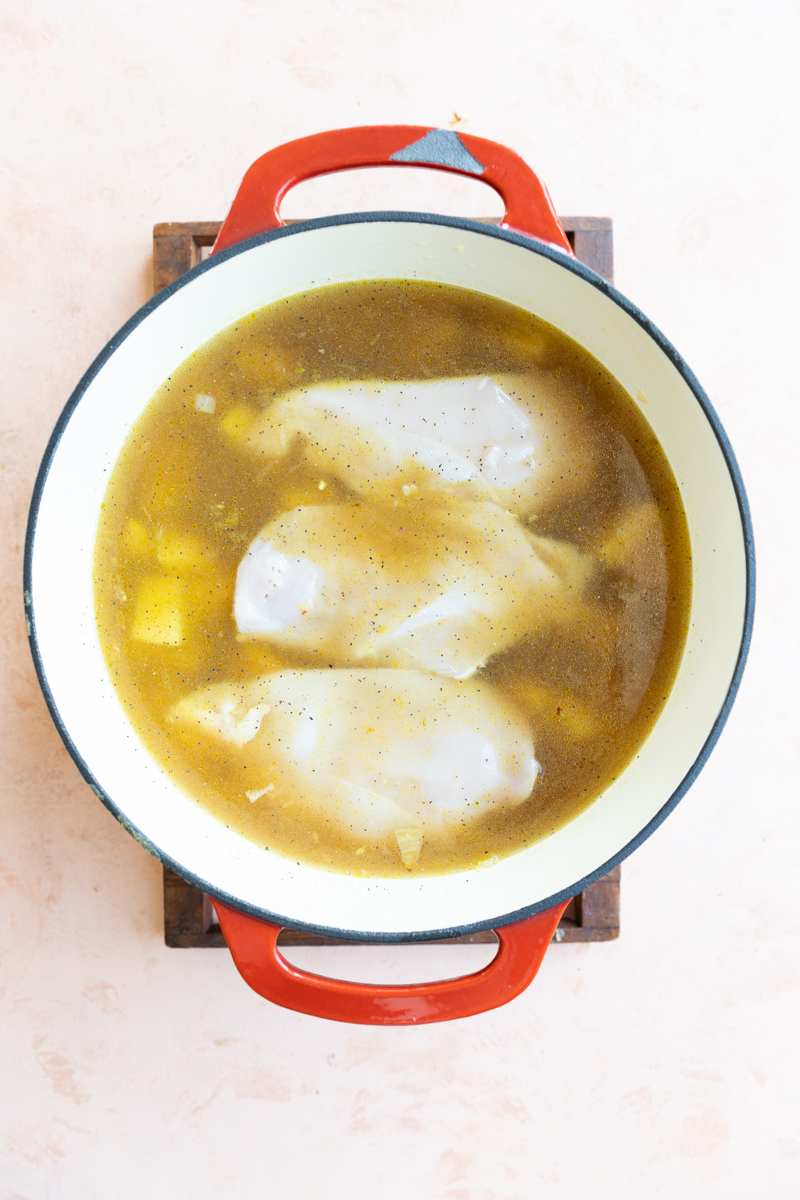Potatoes, chicken, broth, and water in dutch oven.