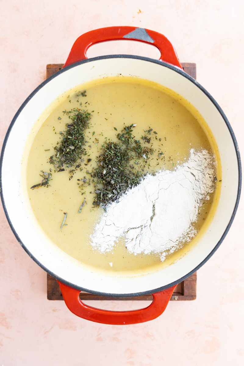 Herbs and flour poured on top of creamy broth.