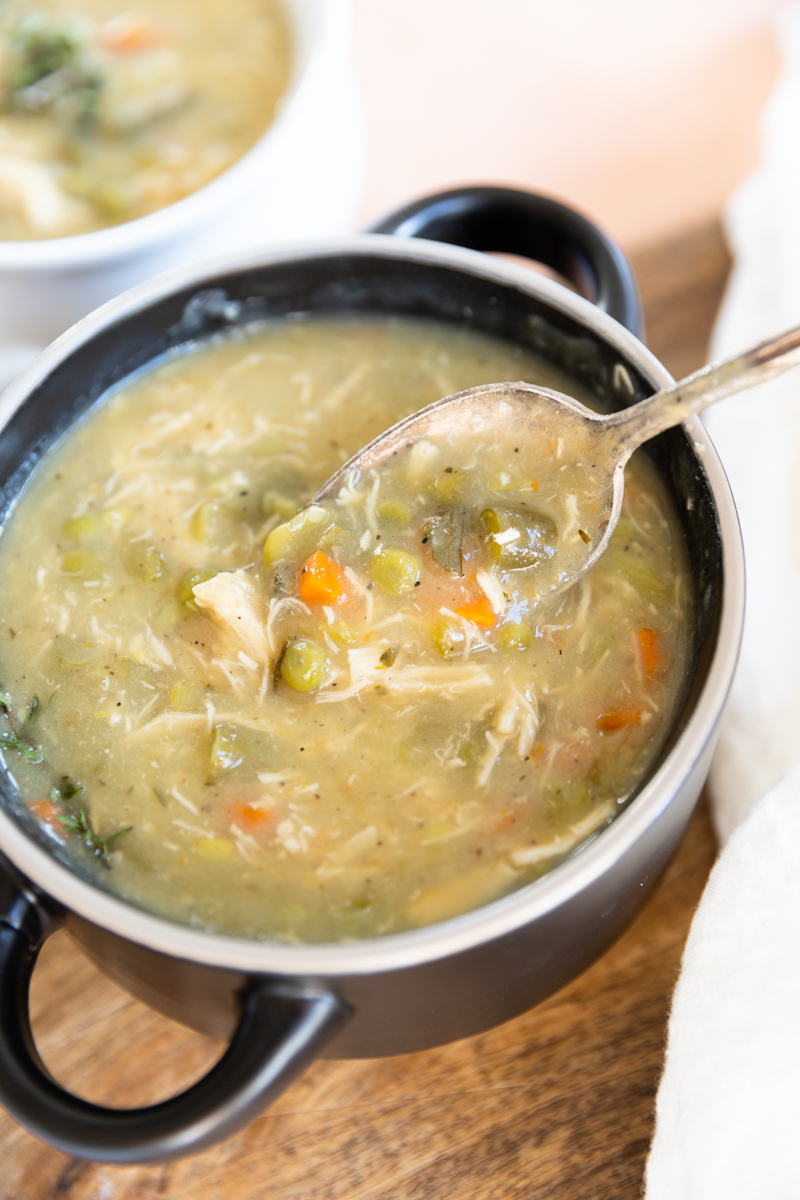 Spoon scooping out a bite of chicken pot pie soup.