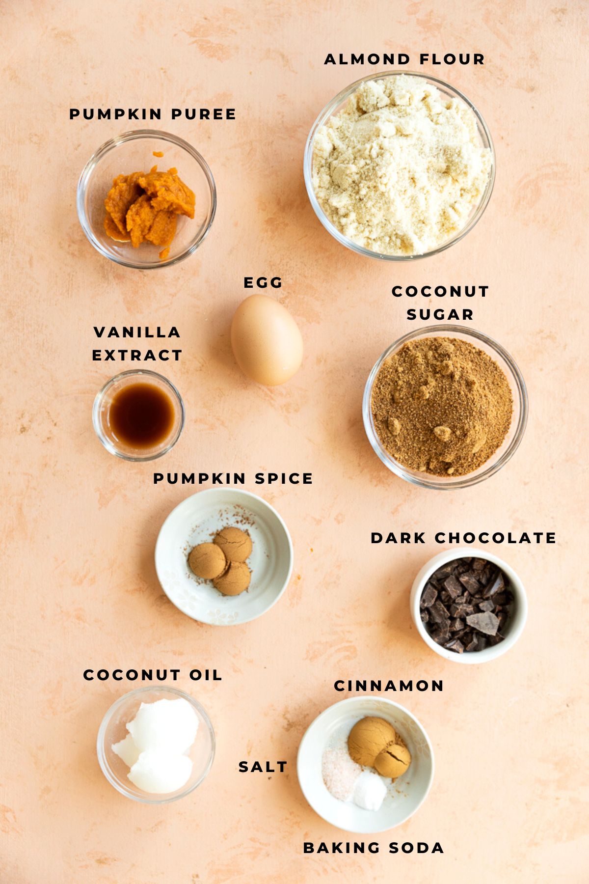 Ingredients for pumpkin chocolate chip cookies measured out into small bowls.