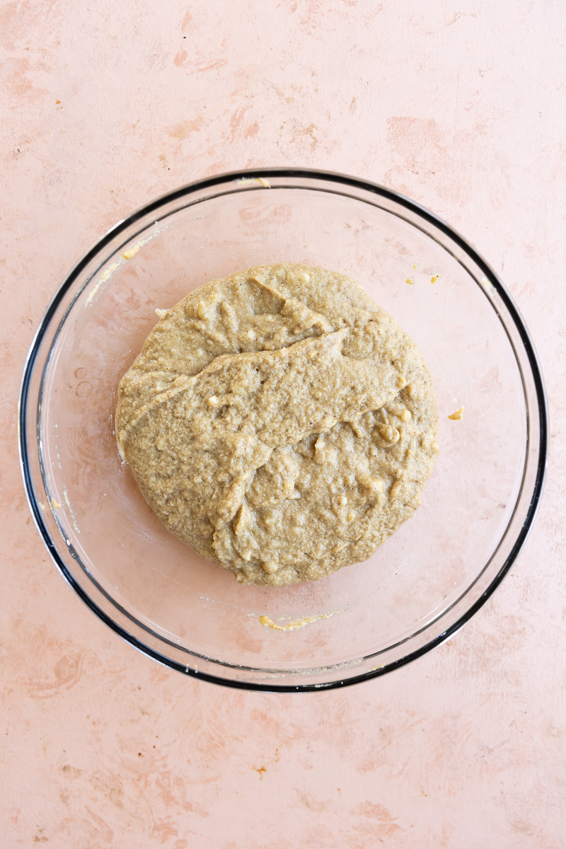 Banana cake batter folded together in glass bowl.