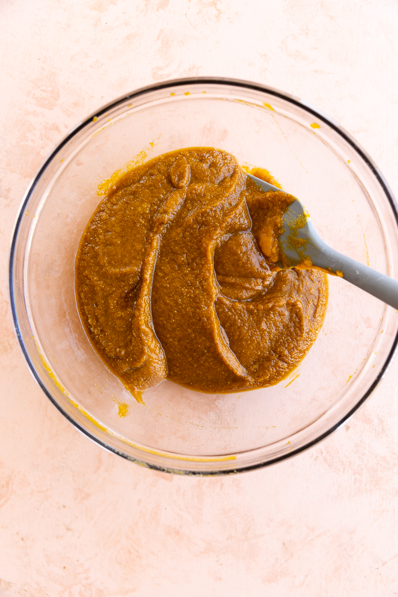 Creamy pumpkin pie filling in glass bowl.
