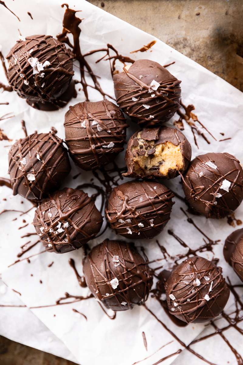 Overhead picture of cookie dough truffles dipped in dark chocolate.