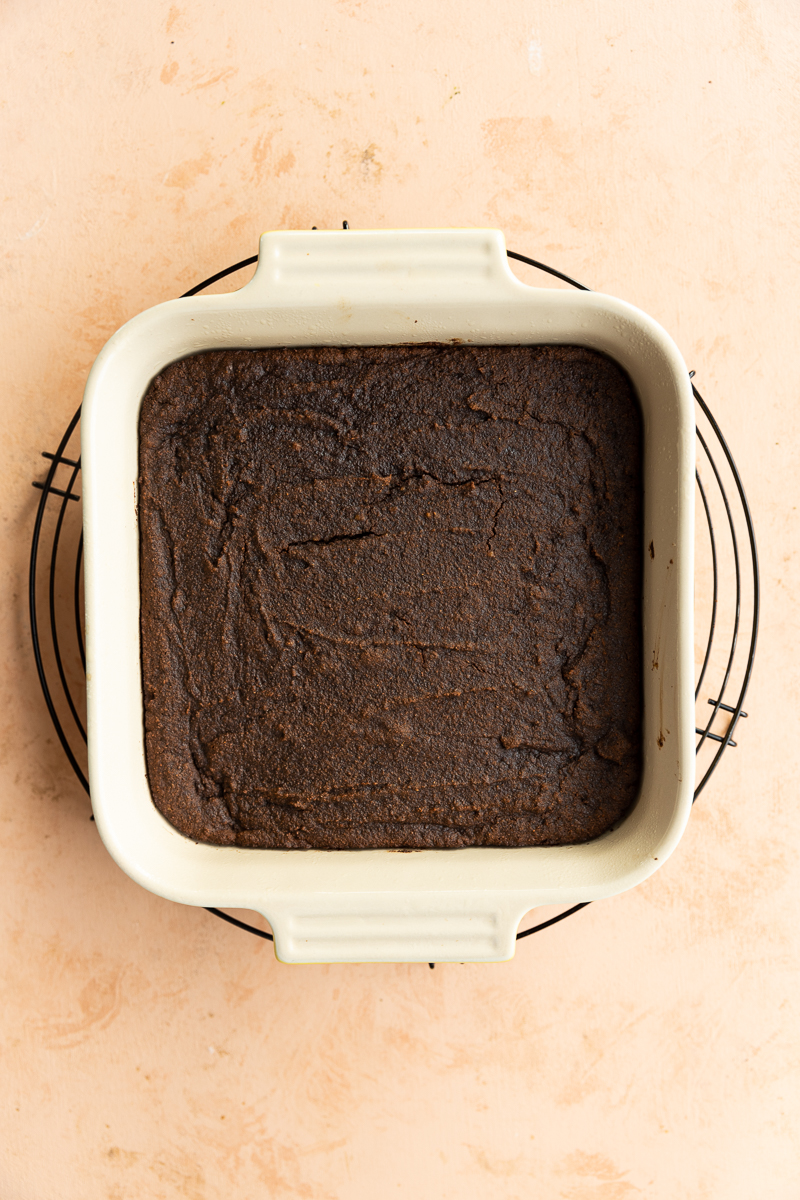 Baked gingerbread cookie bars in square pan.
