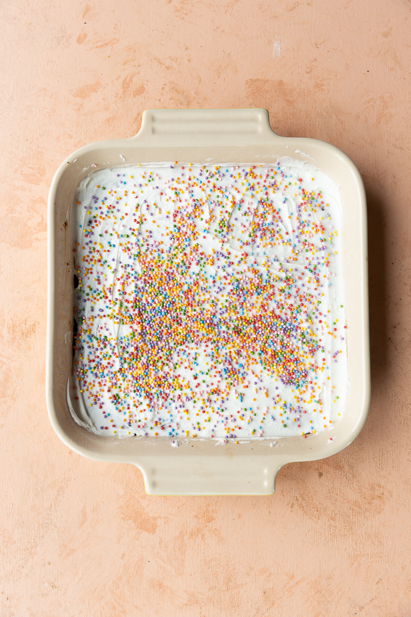 Gingerbread cookie bars frosted with sprinkles.