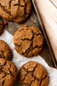 Close up picture of molasses cookie on a baking sheet.