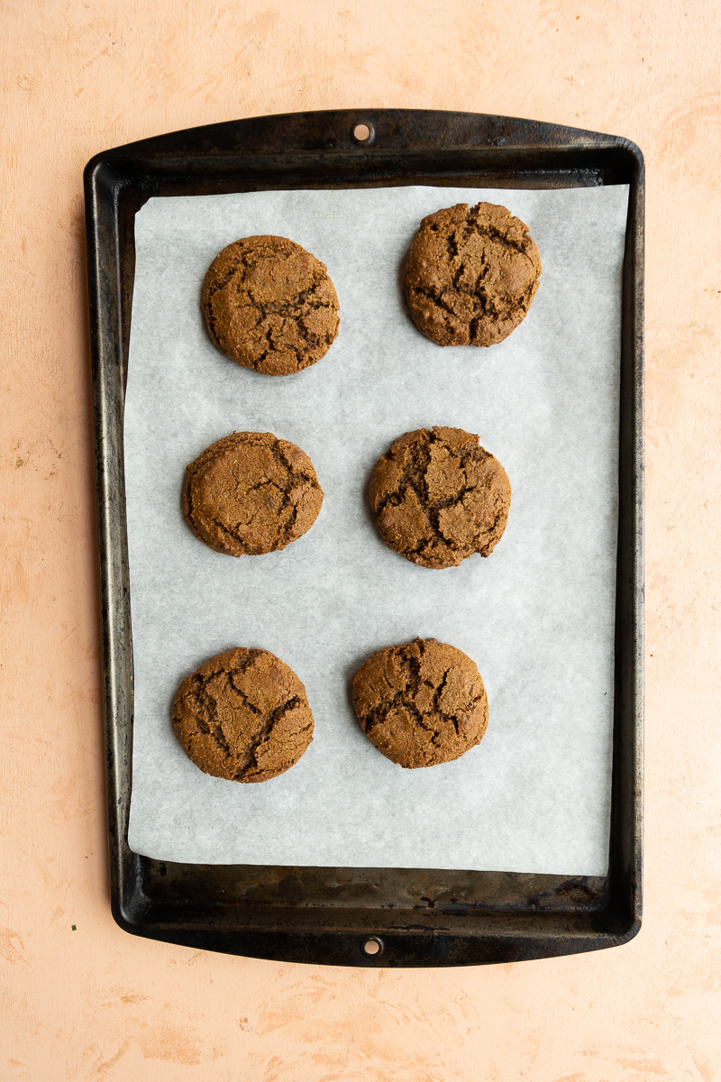 Baked cookies on parchment paper lined baking sheet.