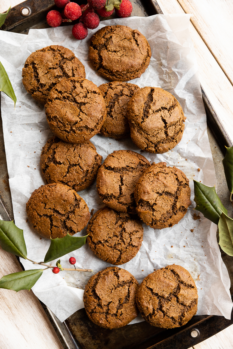 Gluten-Free molasses cookies layered on a baking sheet.