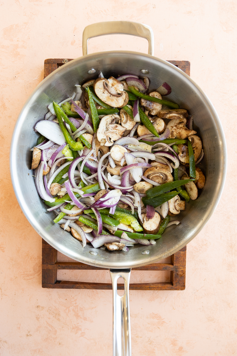 Vegetables cooking in large skillet.