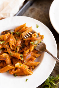 Close up picture of fork in pasta dish.