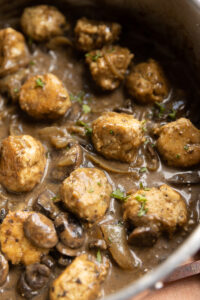 Chicken meatballs in gravy with mushrooms.