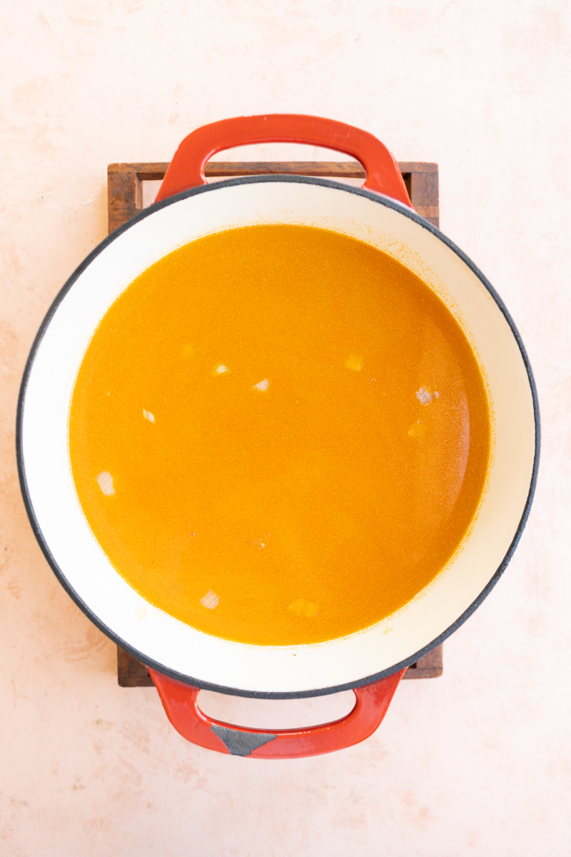 Broth, chicken breast, carrots, and celery in dutch oven.