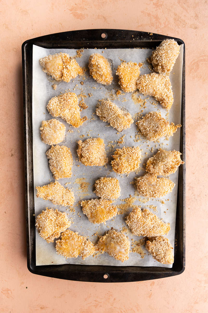 Baked breaded chicken on a baking sheet.