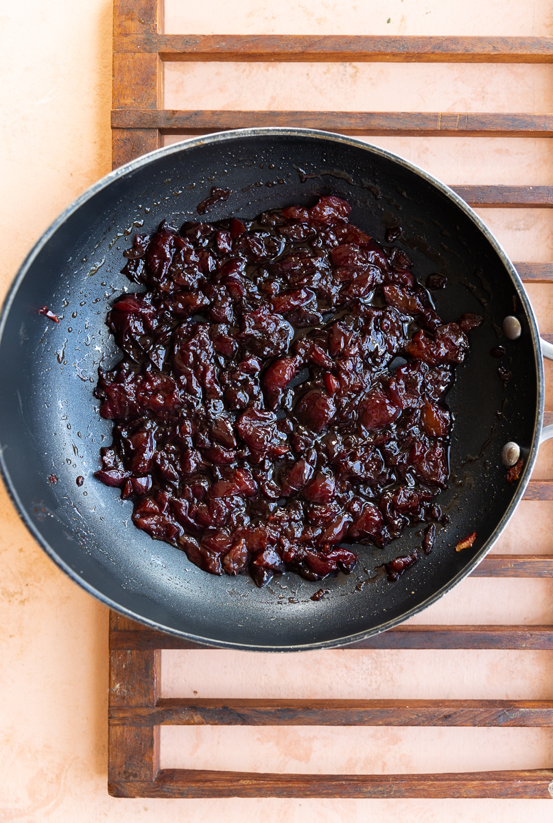 Cooked cherries in a skillet.
