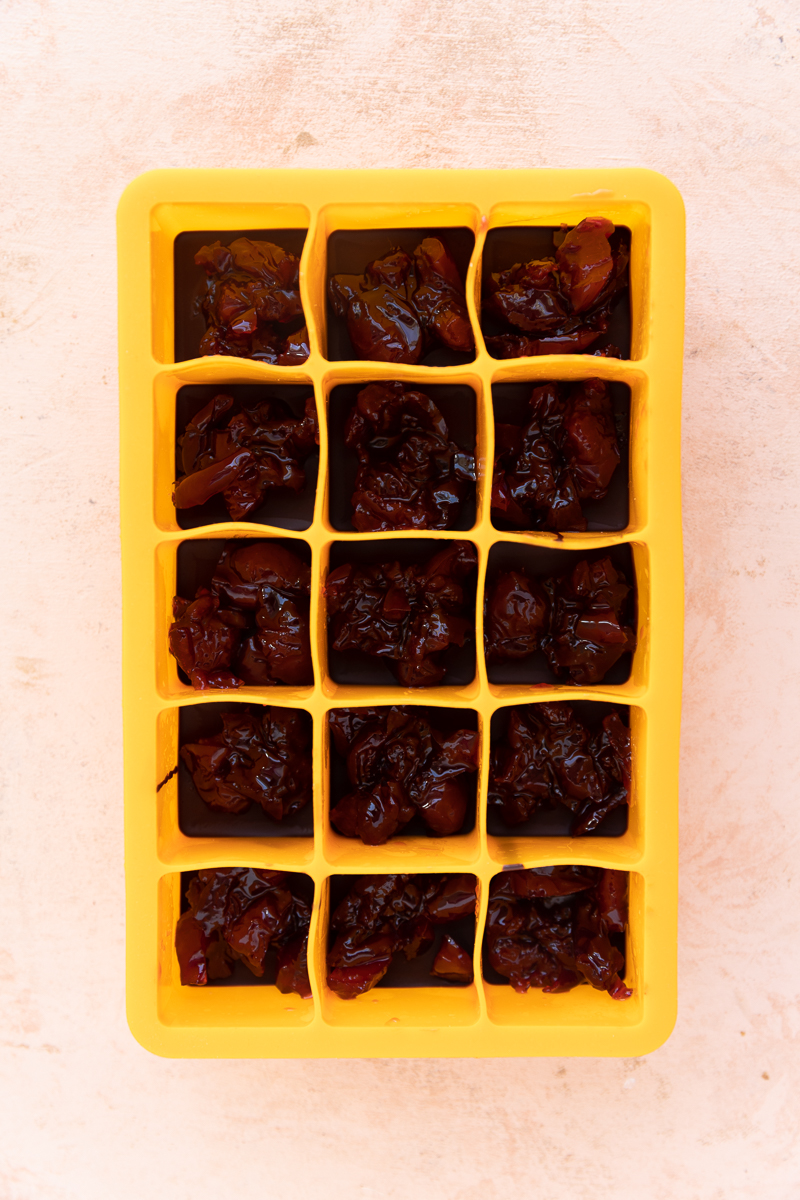 Chocolate and cherry filling in candy mold.