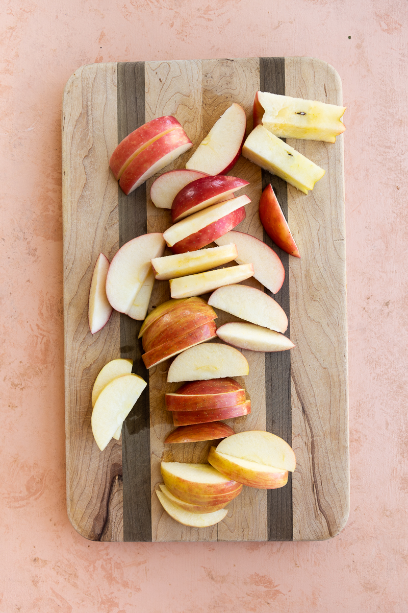 Cutting board with apple slices.