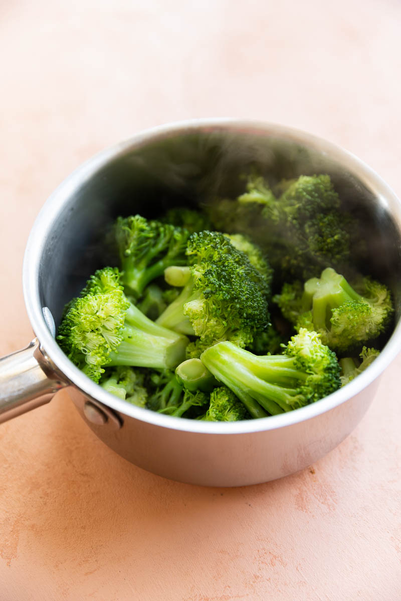 Steamed broccoli in a small saucepan.