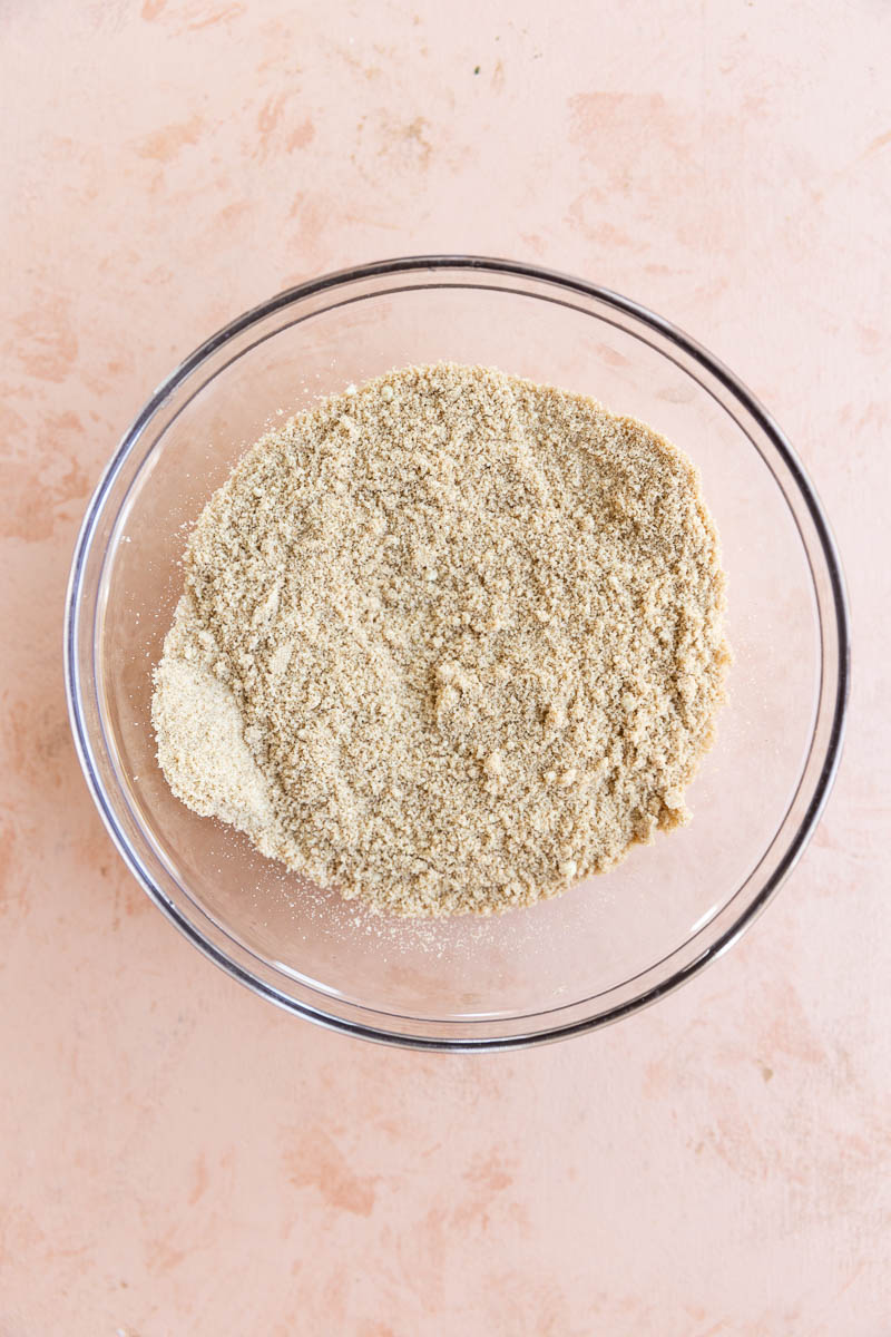 Dry ingredients for zucchini muffins in a bowl.