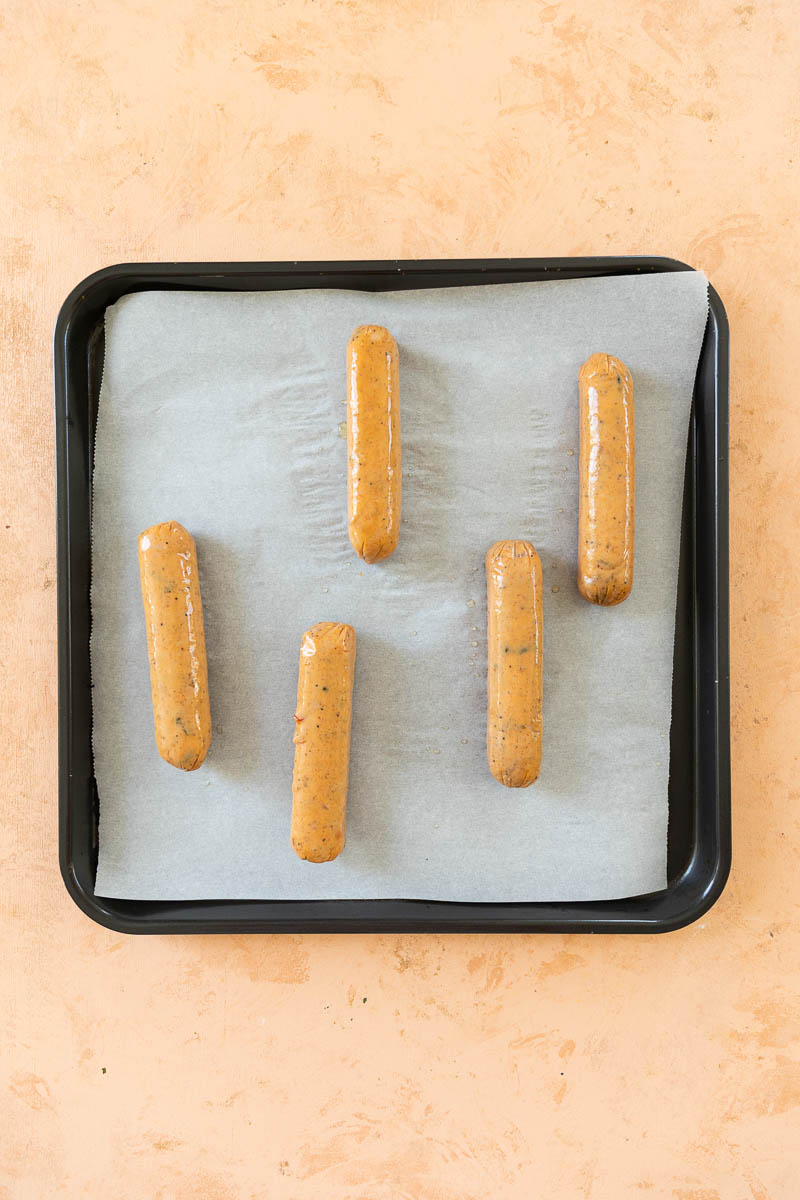 Chicken sausage on a baking tray.