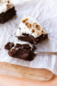 Slice of chocolate carrot cake with a big bite on a spoon.