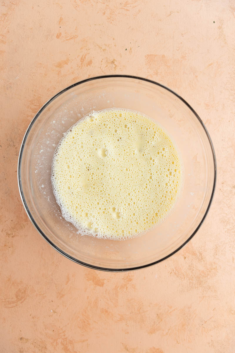 Wet ingredients in a glass mixing bowl.