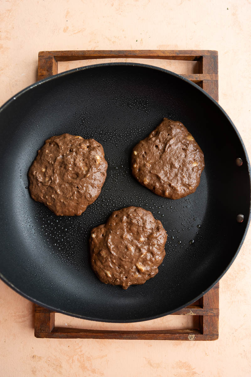 Pancakes cooking on a non stick skillet.