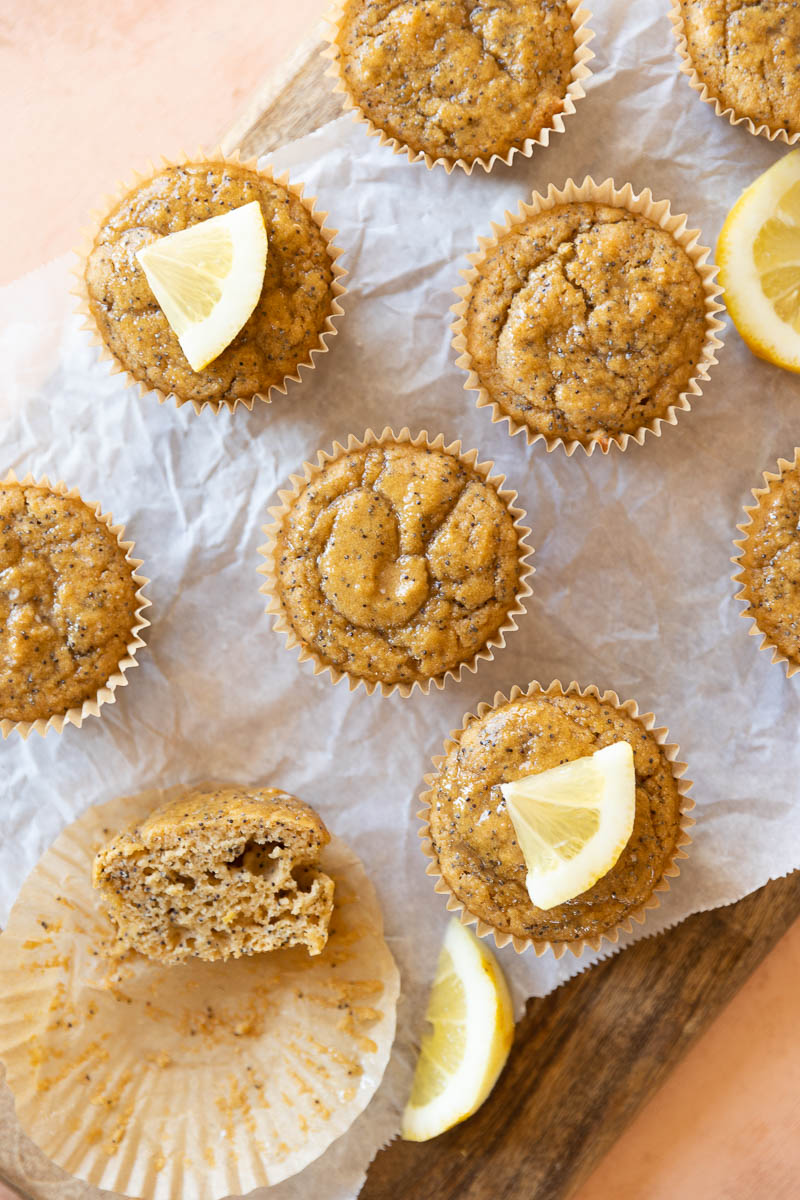 Lemon poppyseed cupcakes with one cupcake cut in half.