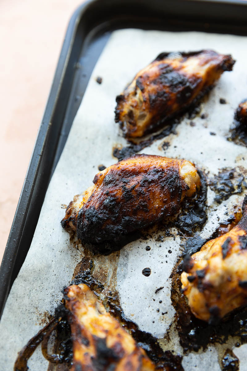 Air fried wings on a parchment paper lined baking sheet.