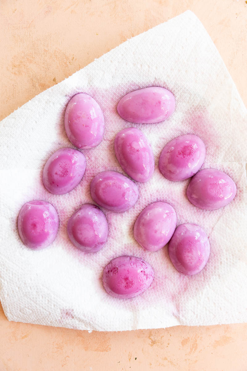 Pink eggs on a paper towel.