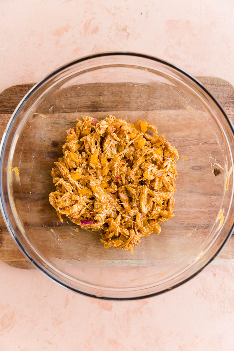 Buffalo chicken filling in a glass mixing bowl.