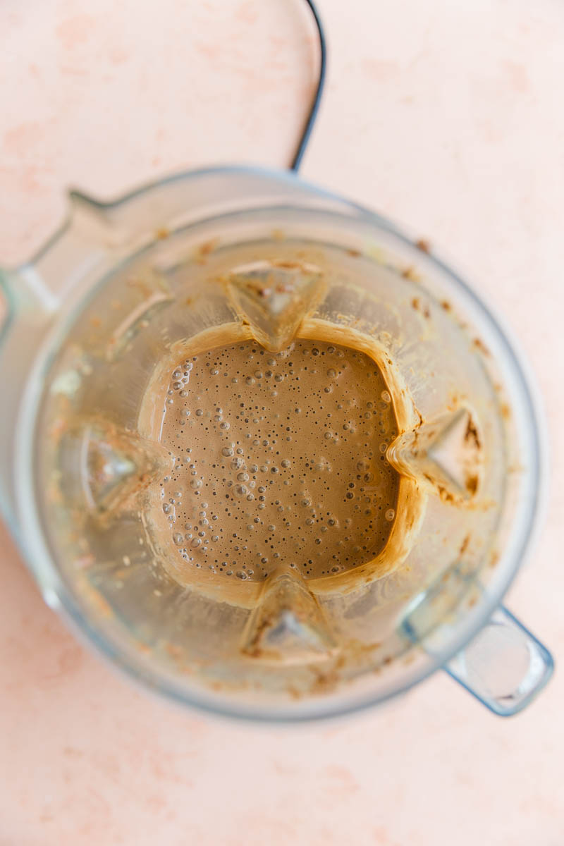 Creamy chocolate banana protein shake in blender.