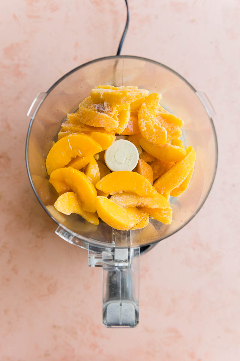 Frozen peaches in a food processor.