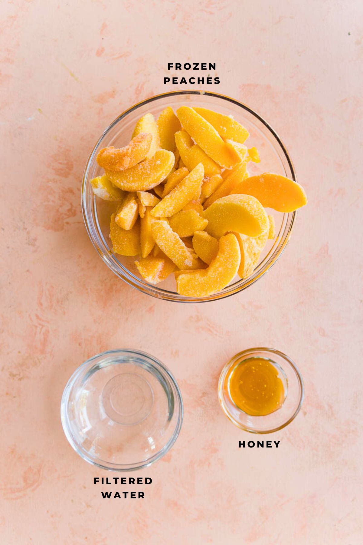 Ingredients measured out in small bowls for peach sorbet.