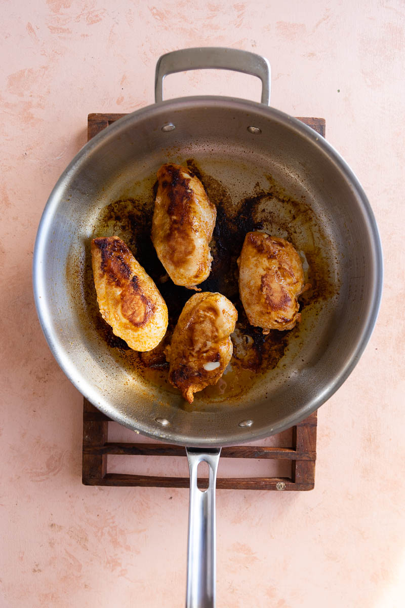 Cooked chicken in a skillet.