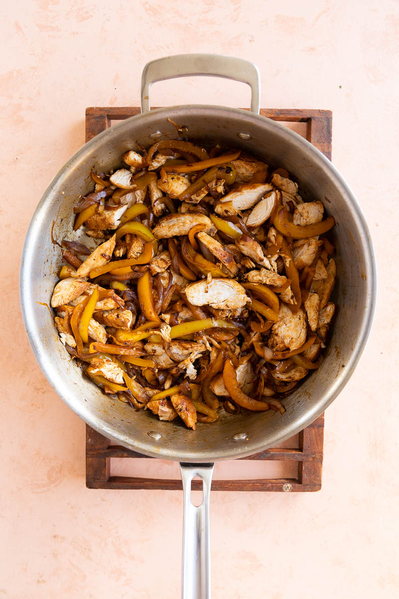 Cooked onions, peppers, and chicken.