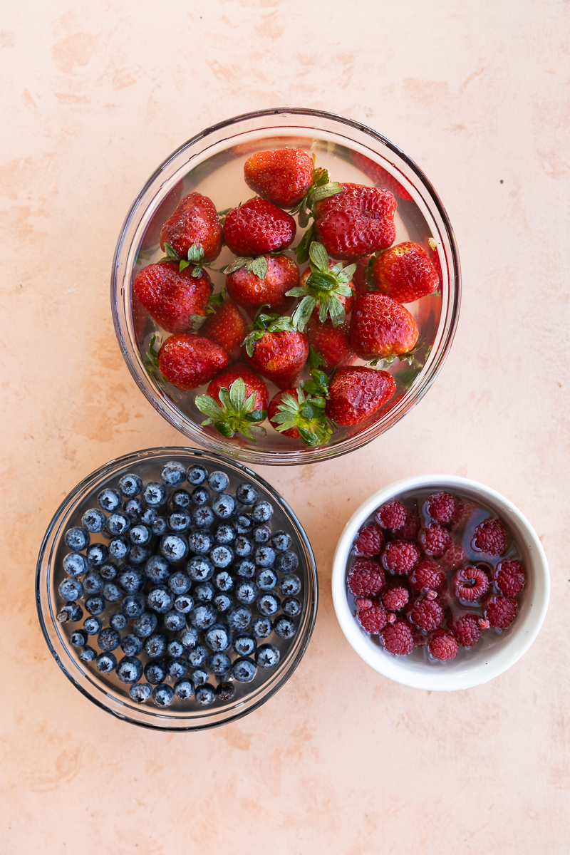 Berries soaking in simple fruit wash.