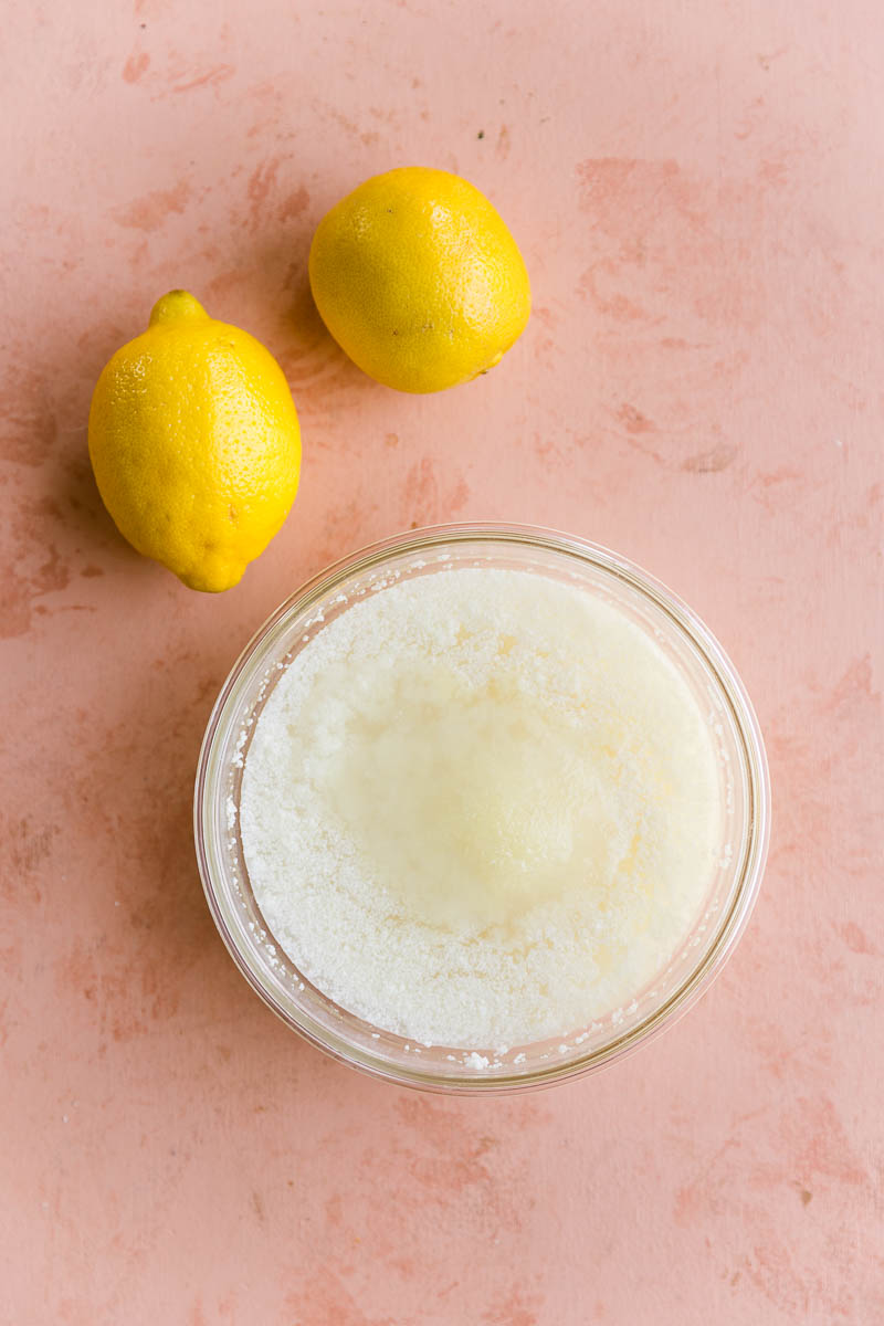 Frozen lemon sorbet in a glass tupperware bowl.