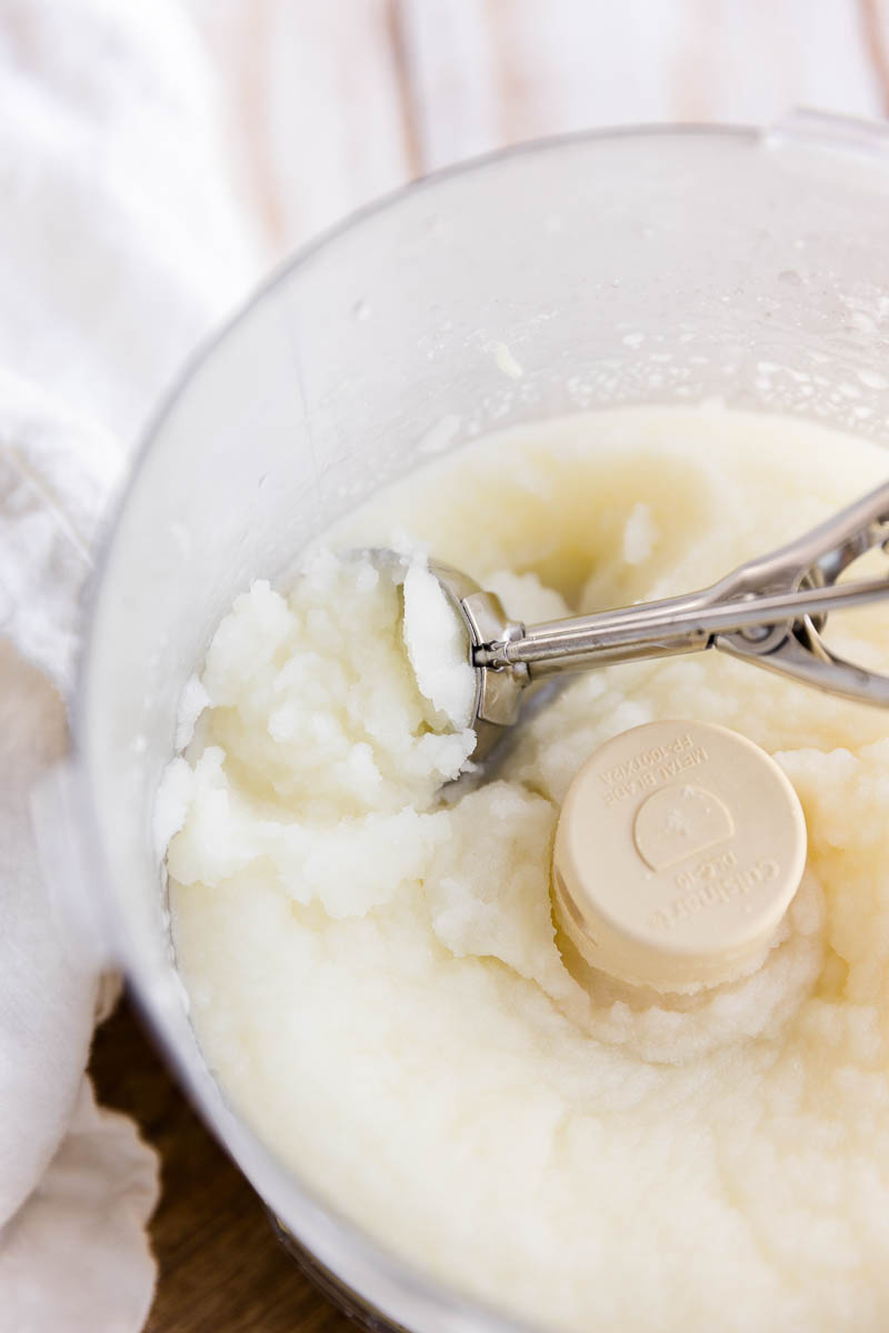 Ice cream scoop in creamy lemon sorbet.