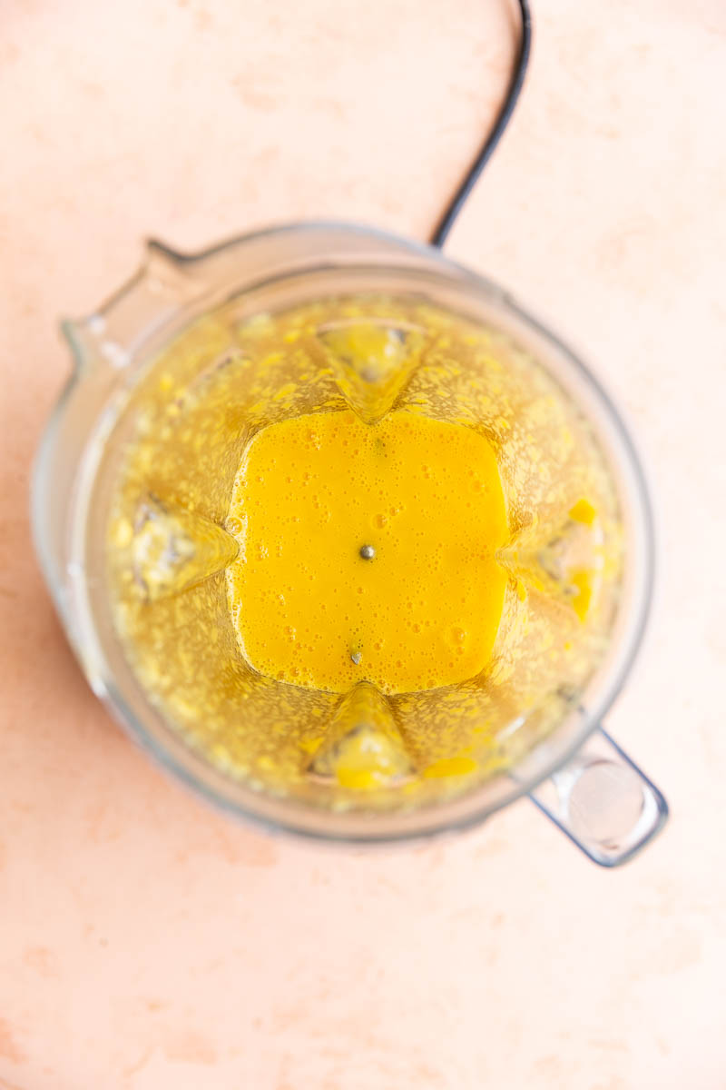 Blended orange popsicle ingredients in blender.