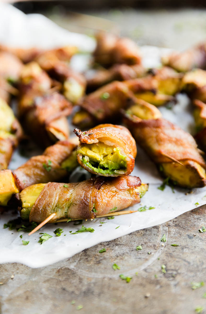 Bacon wrapped avocado with bite taken out.