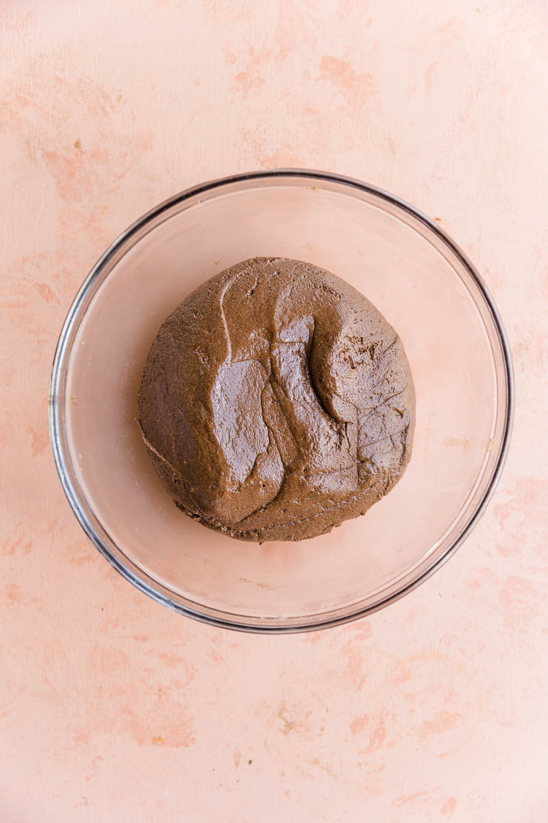 Chocolate protein bar dough in a glass bowl.
