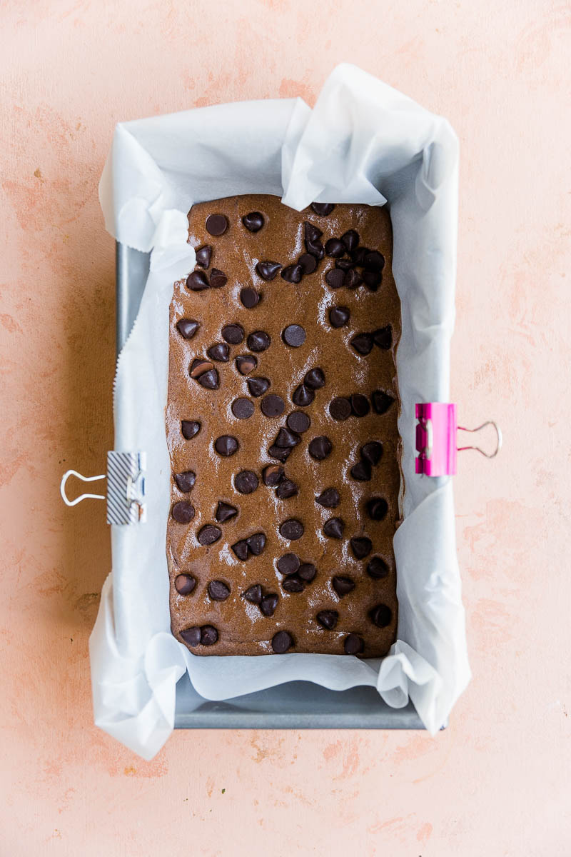 Chocolate protein bar dough pressed into a pan.