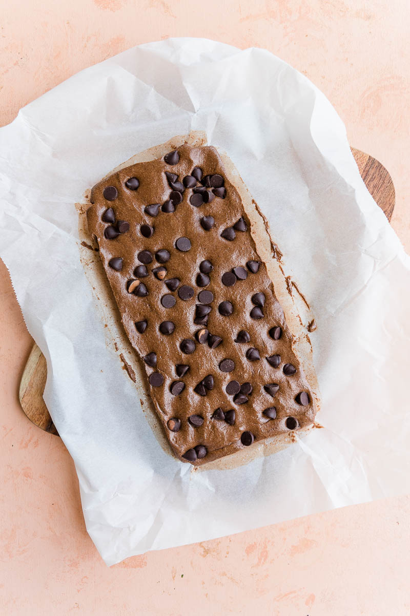 Chilled protein bar dough on parchment paper.