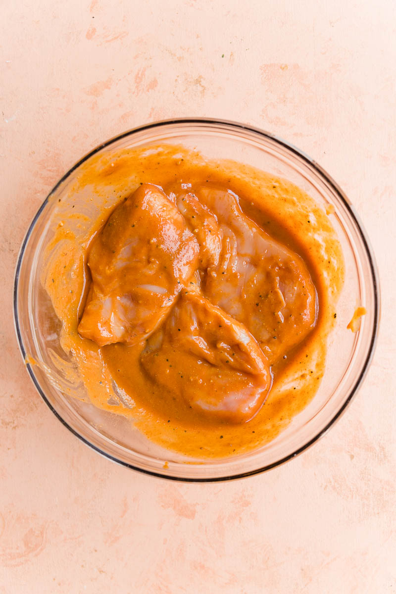 Chicken marinating in bbq sauce.