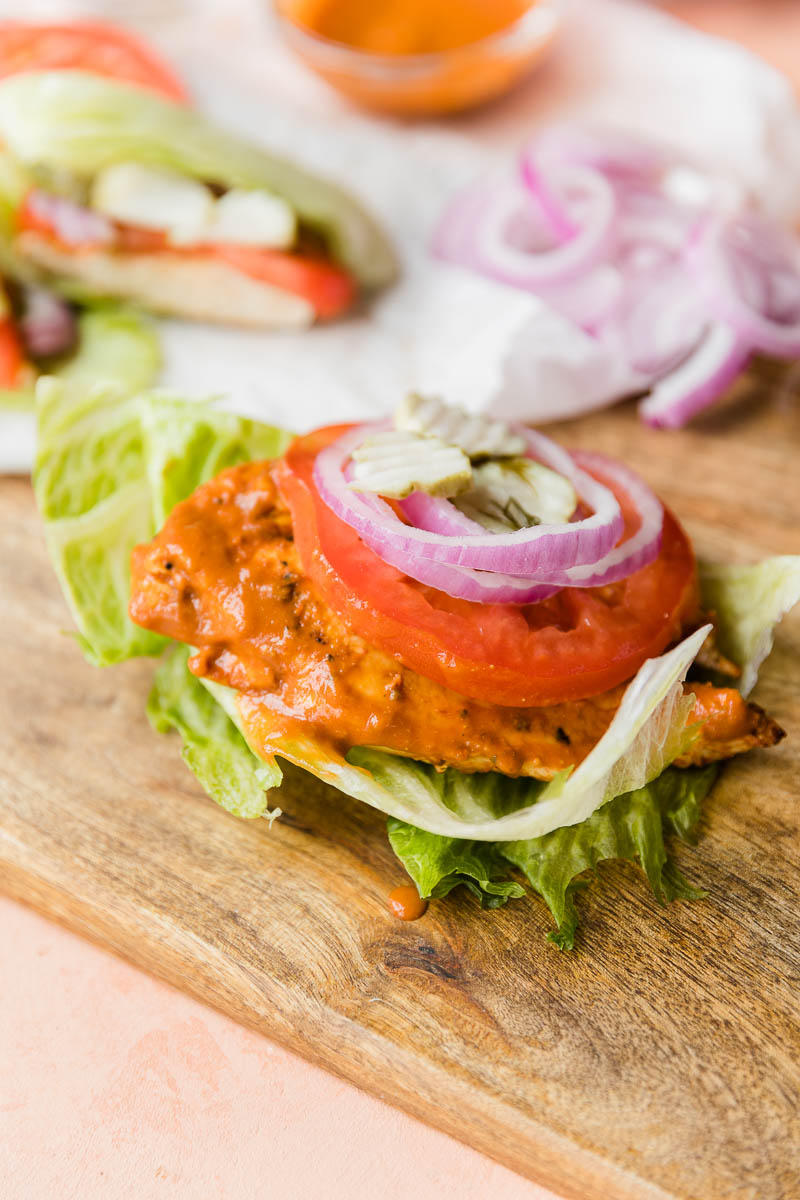 BBQ chicken sandwich with lettuce bun.