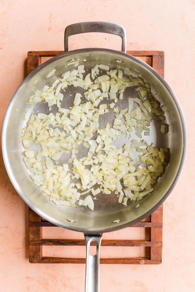 Cooked onions in a frying pan.