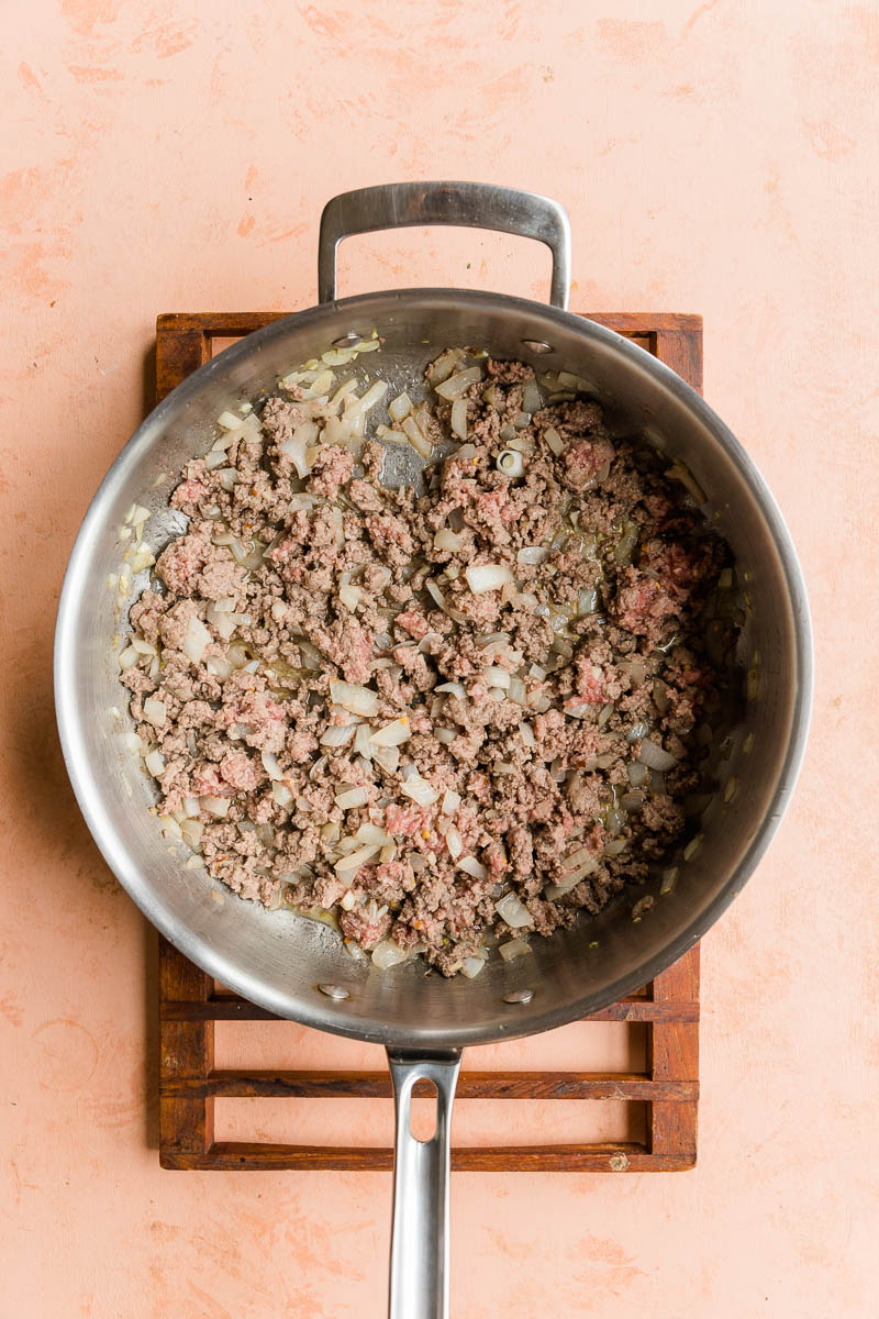 Ground beef cooking with onions.