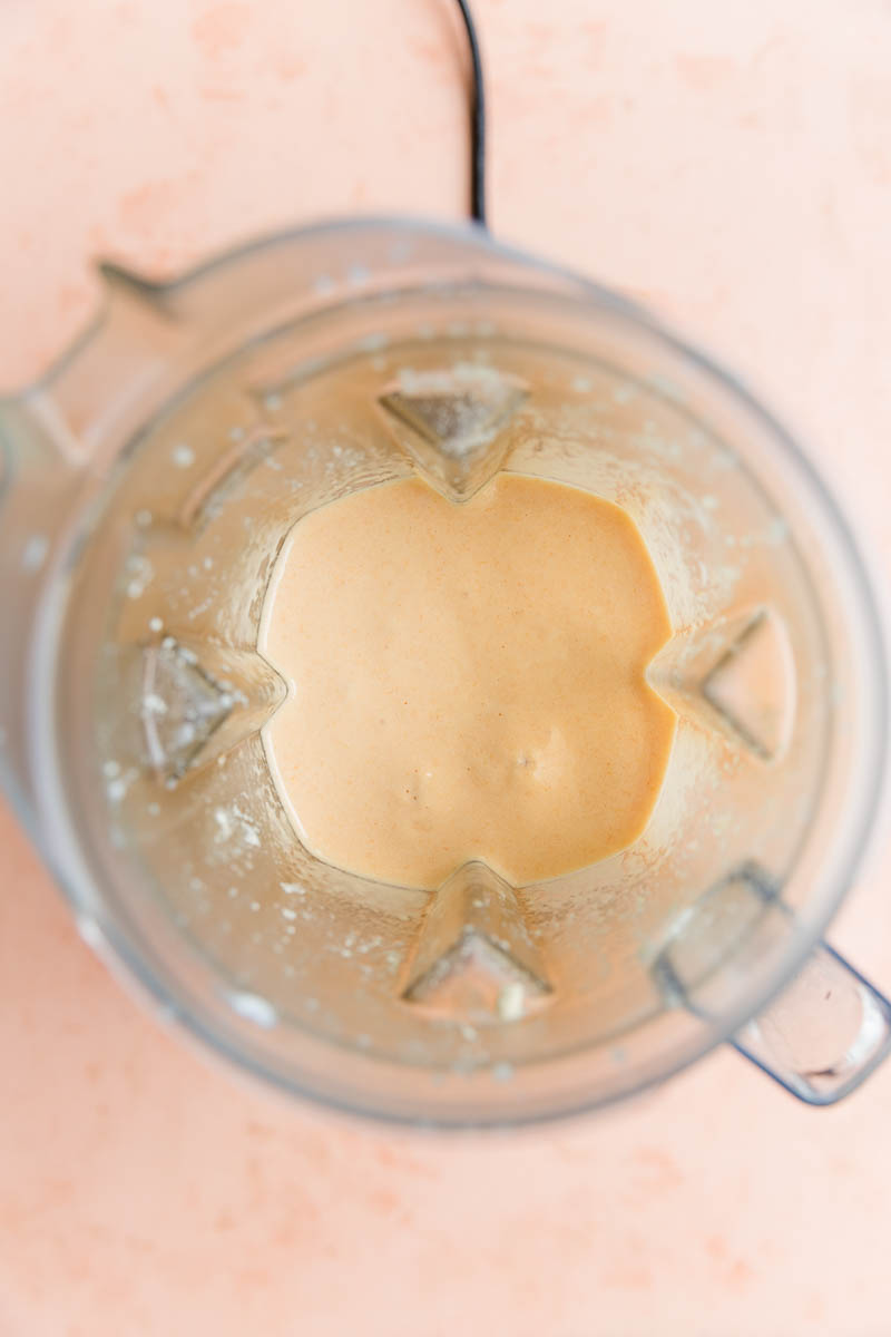 Creamy orange smoothie in blender.