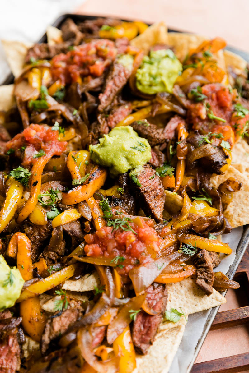 Steak fajita nachos on a baking sheet.