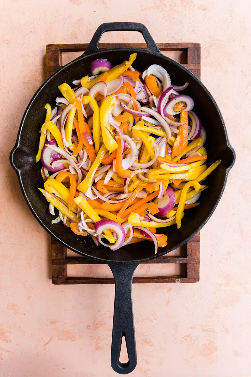 Peppers and onion in cast iron skillet.